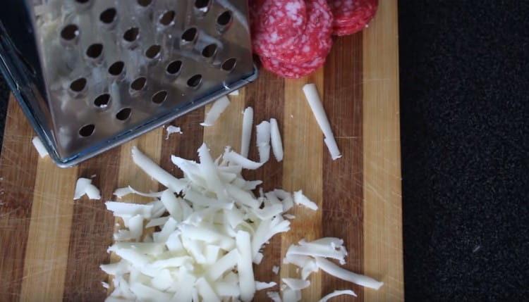 Grate the cheese, cut the salami.