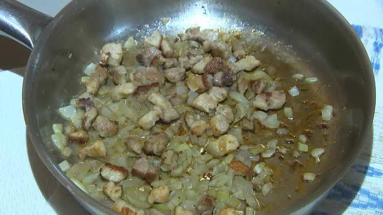 fry onion with meat in a pan