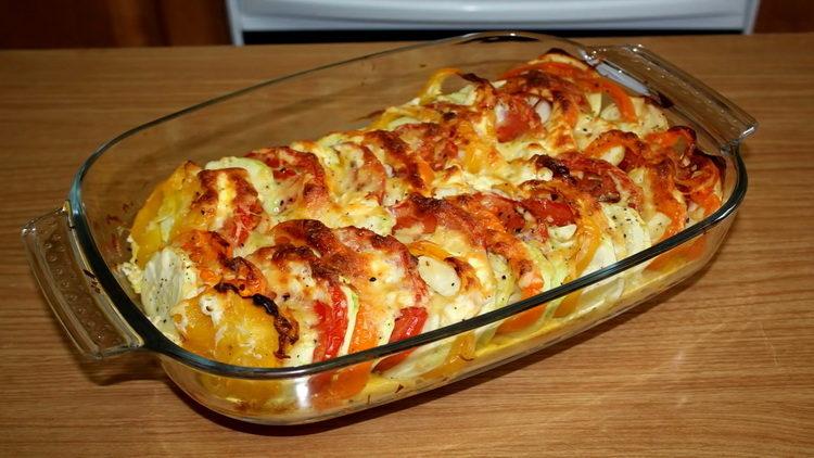 Oven with zucchini with tomatoes and cheese in the oven