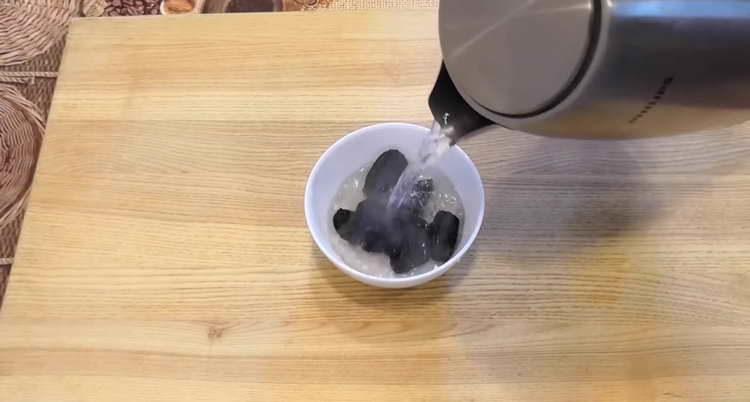 pour prunes with boiling water