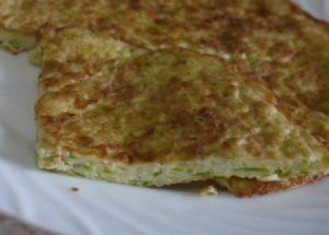 cooking an air omelet with zucchini in a pan