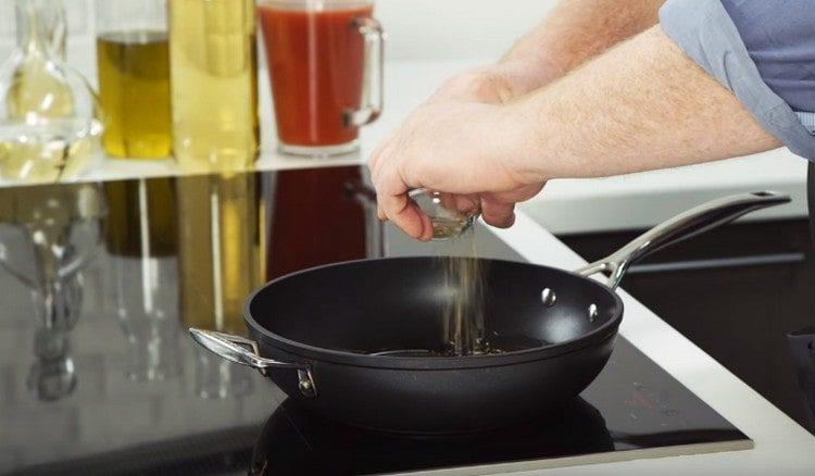 pour vegetable oil into the pan, add oregano and cumin.