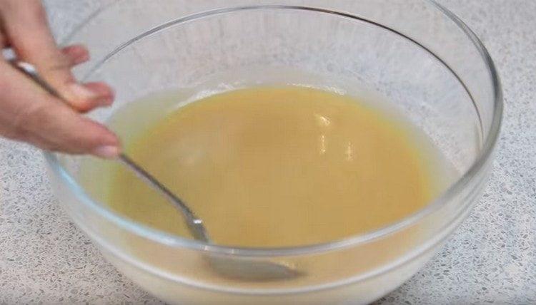 Pour applesauce into a bowl.