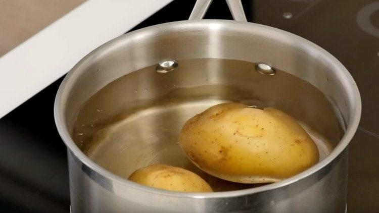 Boil the potatoes until tender.