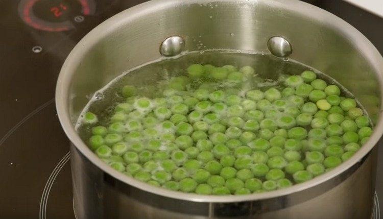 Boil green peas for several minutes.