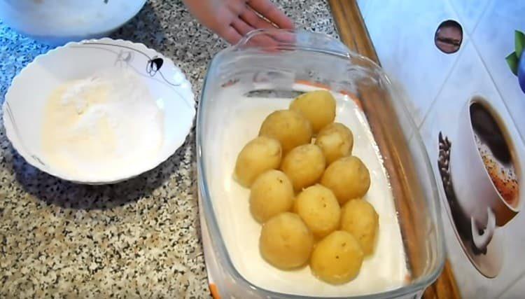 Put the boiled potatoes in the baking dish.