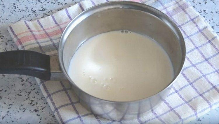 Pour milk and water into the pan.