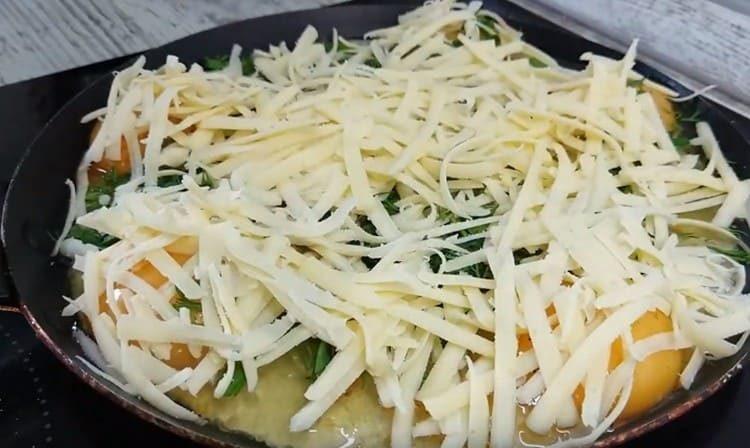 Sprinkle the eggs with greens and grated cheese immediately.