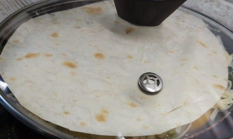 Cover the workpiece with a second sheet of pita bread.
